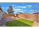 A private backyard featuring artificial turf, brick patio, and desert landscaping at 2910 Ventana Ridge Ave, Henderson, NV 89044