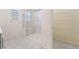Bright bathroom with tiled floor, a glass shower and a glimpse into an organized closet with wire shelving at 2910 Ventana Ridge Ave, Henderson, NV 89044