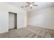 Bedroom featuring plush carpeting, a ceiling fan, and a closet with convenient shelving at 2910 Ventana Ridge Ave, Henderson, NV 89044