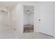 Bright entryway with white tile flooring, leading to a carpeted room with ceiling fan at 2910 Ventana Ridge Ave, Henderson, NV 89044