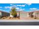 Charming single-story home featuring desert landscaping, a brick driveway, and a two-car garage at 2910 Ventana Ridge Ave, Henderson, NV 89044