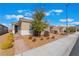 Inviting single-story home with brick walkway, desert landscaping, and a charming front door at 2910 Ventana Ridge Ave, Henderson, NV 89044