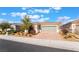 Charming single-story home featuring desert landscaping, a brick driveway, and a two-car garage at 2910 Ventana Ridge Ave, Henderson, NV 89044