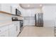 Modern kitchen boasts stainless steel appliances, white cabinets, and ample counter space at 2910 Ventana Ridge Ave, Henderson, NV 89044