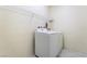A well-equipped laundry room featuring a washer, dryer, and wire shelving for optimal organization at 2910 Ventana Ridge Ave, Henderson, NV 89044