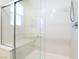 Modern walk-in shower features glass doors, a built-in seat, and sleek chrome fixtures at 2910 Ventana Ridge Ave, Henderson, NV 89044