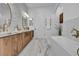 Elegant bathroom with wood cabinets, marble countertops, and a stylish soaking tub at 2925 Hidden Hollow Cir, Logandale, NV 89021