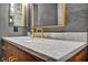 Bathroom vanity with marble countertops, bronze faucet, and dark wood cabinets offers ample storage at 2925 Hidden Hollow Cir, Logandale, NV 89021