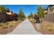 Long community walkway with green trees and landscaping at 3038 Versace Ave, Las Vegas, NV 89141