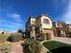 View of a charming two-story home with desert landscaping at 3038 Versace Ave, Las Vegas, NV 89141