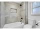 Modern bathroom featuring neutral tile, a shower-tub combination, and sleek black fixtures, creating a spa-like ambiance at 3049 Cedar St, Las Vegas, NV 89104