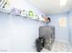 Efficient laundry room featuring modern appliances, storage shelves, and stylish patterned flooring at 3216 Jevonda Ave, Henderson, NV 89044