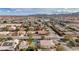 Neighborhood aerial view showcases desert landscaping, single Gathering homes, and community against a backdrop of mountains at 344 E Rush Ave, Las Vegas, NV 89183