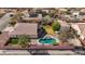 Aerial view of a home's backyard featuring a pool, manicured lawn, and separate two-car garage at 344 E Rush Ave, Las Vegas, NV 89183