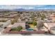 Aerial view of a home featuring a kidney-shaped pool surrounded by lush trees in a desert community at 344 E Rush Ave, Las Vegas, NV 89183