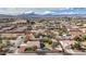 Aerial view of a residential neighborhood with single-Gathering homes, some with pools, against a mountain backdrop at 344 E Rush Ave, Las Vegas, NV 89183