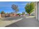 Large backyard with a concrete patio, basketball court, small pool, and mature landscaping at 344 E Rush Ave, Las Vegas, NV 89183