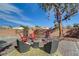 Relaxing backyard with a fire pit, seating, and manicured landscaping at 344 E Rush Ave, Las Vegas, NV 89183
