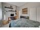 Well-lit bedroom featuring a desk, shelving, and ample closet space at 344 E Rush Ave, Las Vegas, NV 89183