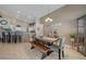 Neutral dining area featuring a wooden table, bench seating, and stylish decor, seamlessly connected to the open kitchen at 344 E Rush Ave, Las Vegas, NV 89183