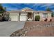 Lovely single-story home boasts a three-car garage and desert landscaping for easy upkeep at 344 E Rush Ave, Las Vegas, NV 89183