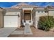 Inviting front entrance with well-manicured landscaping and charming front-facing three-car garage at 344 E Rush Ave, Las Vegas, NV 89183