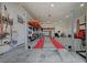 Well-equipped garage interior with a car lift, workbenches, and organized storage solutions for automotive enthusiasts at 344 E Rush Ave, Las Vegas, NV 89183