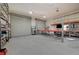 Well-equipped garage with car lift and large roll-up doors, perfect for auto enthusiasts or hobbyists at 344 E Rush Ave, Las Vegas, NV 89183