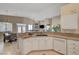 Well-lit kitchen featuring granite counters, white cabinetry, and stainless steel appliances, seamlessly connecting to the dining area at 344 E Rush Ave, Las Vegas, NV 89183