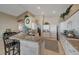 Bright kitchen with granite countertops, white cabinetry, stainless appliances and a view of the laundry room at 344 E Rush Ave, Las Vegas, NV 89183