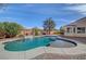 Backyard pool with blue water, waterfall feature, and elegant stone trim at 344 E Rush Ave, Las Vegas, NV 89183