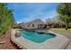 Relaxing backyard pool with stone trim and mature landscaping at 344 E Rush Ave, Las Vegas, NV 89183