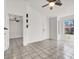 Living room with neutral tile flooring, ceiling fan, and natural light streaming through the window at 3682 Melonies Dr # 5, Las Vegas, NV 89103