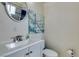 Bathroom featuring a vanity with sink and a round mirror with wall art at 4047 Village Sq, Las Vegas, NV 89121