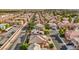 High-angle aerial showcasing a neighborhood street lined with residences, some featuring solar panels at 4664 Stuttgart St, Las Vegas, NV 89147