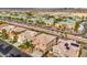 An aerial view showcases houses with mature desert landscaping in a planned community at 4664 Stuttgart St, Las Vegas, NV 89147