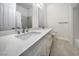 A bathroom featuring double sinks, quartz counters, and tile flooring at 4664 Stuttgart St, Las Vegas, NV 89147