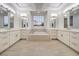 Luxurious bathroom with dual vanities, soaking tub, and ample natural light at 4664 Stuttgart St, Las Vegas, NV 89147