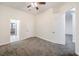 Spacious carpeted bedroom with a ceiling fan, closet, and multiple doors at 4664 Stuttgart St, Las Vegas, NV 89147