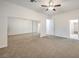 Large bedroom featuring carpet, closet with mirrored doors, and a ceiling fan at 4664 Stuttgart St, Las Vegas, NV 89147