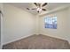 Cozy carpeted bedroom with natural light, a ceiling fan, and neutral walls at 4664 Stuttgart St, Las Vegas, NV 89147