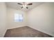 An empty bedroom with neutral colored walls and carpet, along with a ceiling fan at 4664 Stuttgart St, Las Vegas, NV 89147