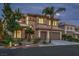 A home with a three-car garage, desert landscaping, and a tile roof stands in the foreground at 4664 Stuttgart St, Las Vegas, NV 89147