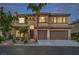 A home with a three-car garage, desert landscaping, and a tile roof stands in the foreground at 4664 Stuttgart St, Las Vegas, NV 89147