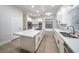 Well-lit kitchen with a large island, stainless steel sink, and modern appliances at 4664 Stuttgart St, Las Vegas, NV 89147