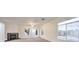 Bright living room with a fireplace, a ceiling fan, and large windows at 4664 Stuttgart St, Las Vegas, NV 89147