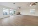 Expansive living room featuring a fireplace, ceiling fans, and abundant natural light at 4664 Stuttgart St, Las Vegas, NV 89147