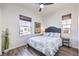 Cozy bedroom with a patterned bedspread, wood-look floors, and a side table at 56 Tatahatso Point St, Henderson, NV 89011