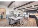 Dining area with a modern chandelier, marble table and seats, open to the kitchen at 56 Tatahatso Point St, Henderson, NV 89011