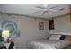 Comfortable bedroom decorated with themed wall art and a decorative ceiling fan at 5705 Petrified Tree Ln, North Las Vegas, NV 89081